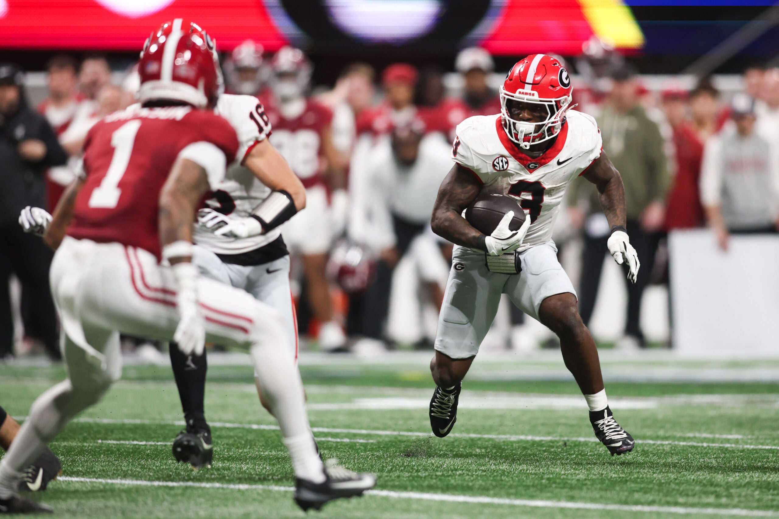 Dec 6, 2025; Atlanta, GA, USA; Georgia Bulldogs running back Nate Frazier (3) rushes as Alabama Crimson Tide defensive back Domani Jackson (1) defends during the third quarter during the 2025 SEC Championship game at Mercedes-Benz Stadium.