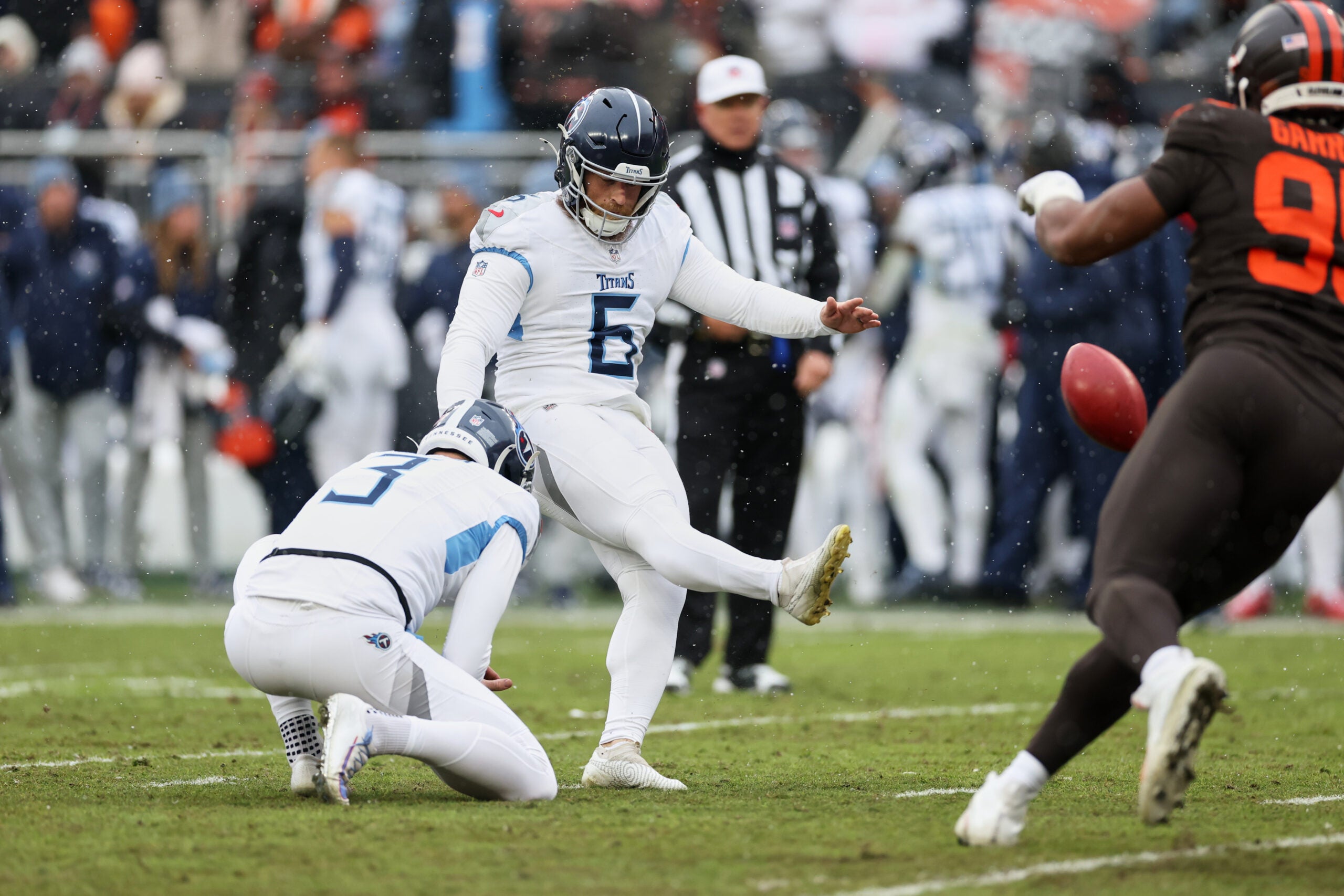 Dec 7, 2025; Cleveland, Ohio, USA; Tennessee Titans placekicker Joey Slye (6) kicks the extra point held by punter Johnny Hekker (3) against the Cleveland Browns during the second quarter at Huntington Bank Field.