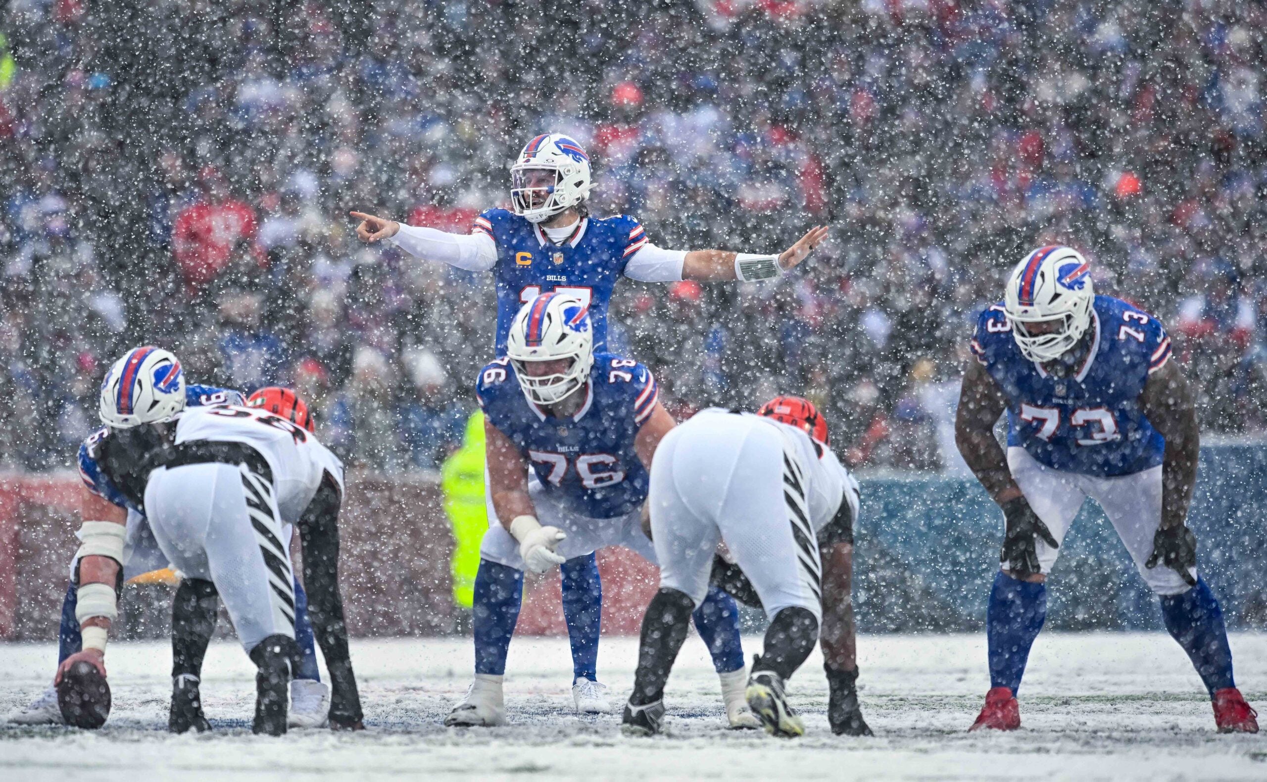 Dec 7, 2025; Orchard Park, New York, USA; Buffalo Bills quarterback Josh Allen (17) at the line of scrimmage with guard David Edwards (76) and offensive tackle Dion Dawkins (73) in the second quarter against the Cincinnati Bengals at Highmark Stadium.