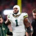 Dec 14, 2025; Denver, Colorado, USA; Green Bay Packers defensive end Micah Parsons (1) walks off the field with help from medical personnel following an injury during the third quarter against the Denver Broncos at Empower Field at Mile High.