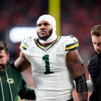 Dec 14, 2025; Denver, Colorado, USA; Green Bay Packers defensive end Micah Parsons (1) walks off the field with help from medical personnel following an injury during the third quarter against the Denver Broncos at Empower Field at Mile High.