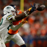 Dec 14, 2025; Denver, Colorado, USA; Green Bay Packers safety Xavier McKinney (29) deflects a pass intended for Denver Broncos wide receiver Courtland Sutton (14) during the fourth quarter at Empower Field at Mile High.