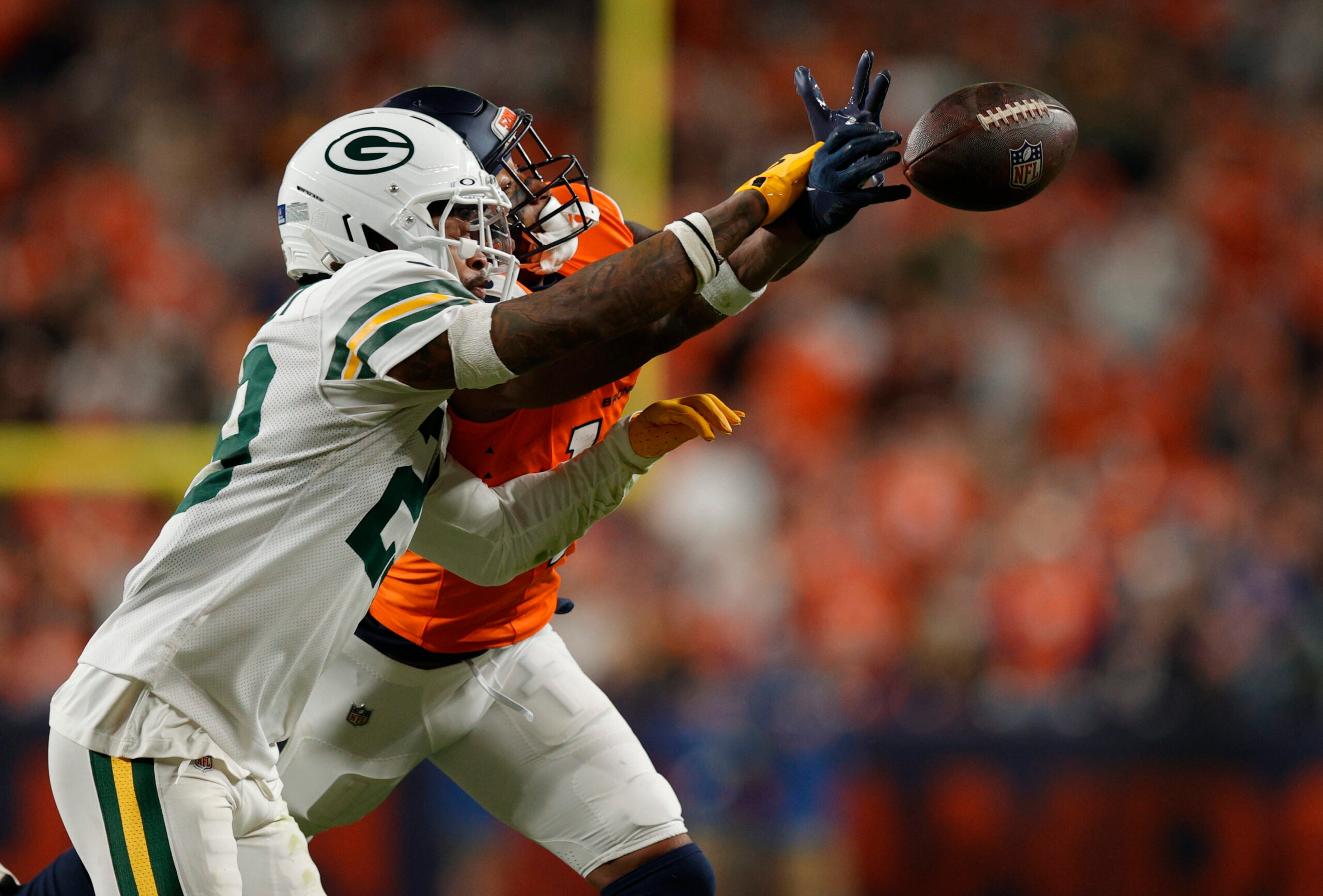 Dec 14, 2025; Denver, Colorado, USA; Green Bay Packers safety Xavier McKinney (29) deflects a pass intended for Denver Broncos wide receiver Courtland Sutton (14) during the fourth quarter at Empower Field at Mile High.