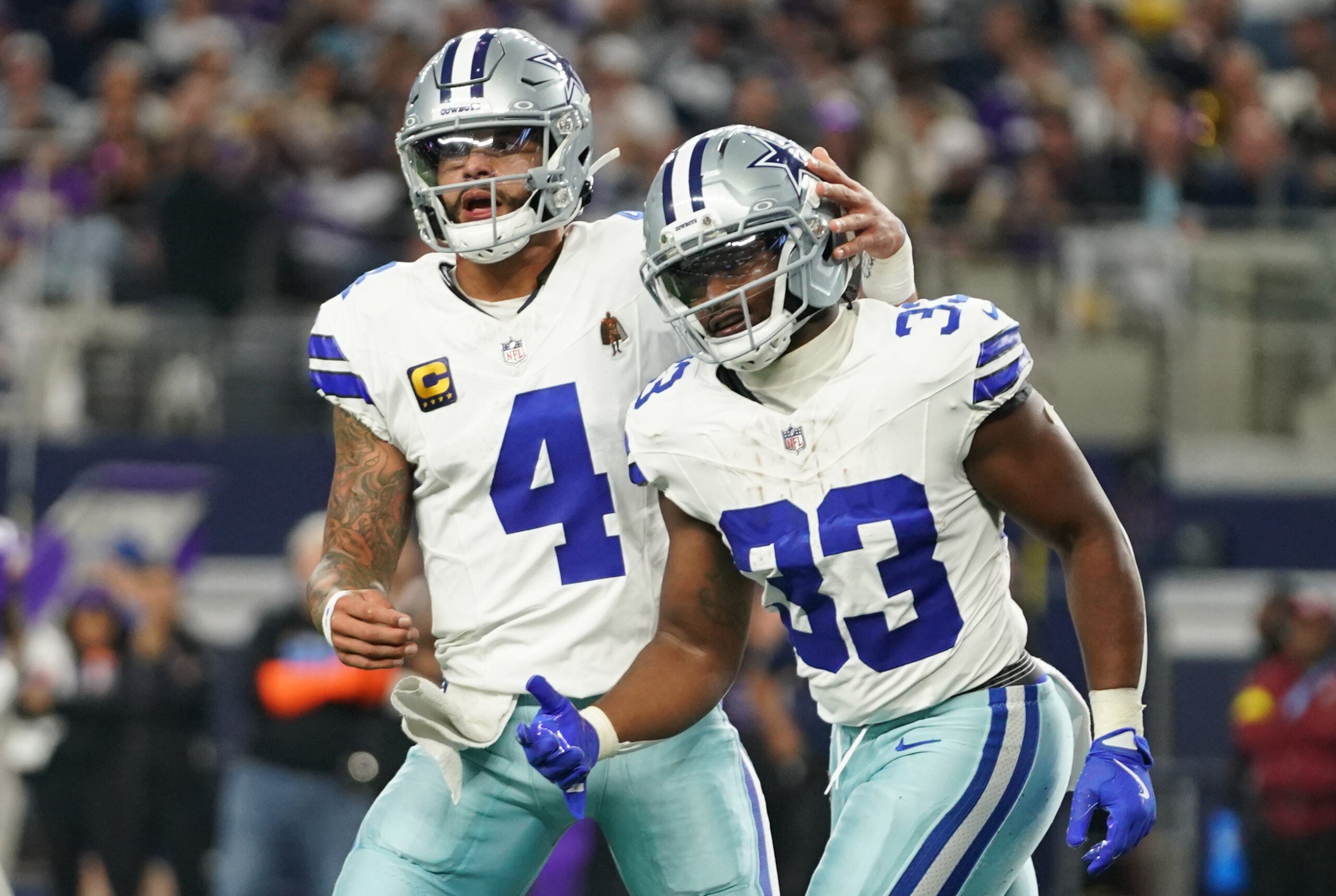 Dec 14, 2025; Arlington, Texas, USA; Dallas Cowboys running back Javonte Williams (33) celebrates with quarterback Dak Prescott (4) after a touchdown during the first half against the Minnesota Vikings at AT&T Stadium.