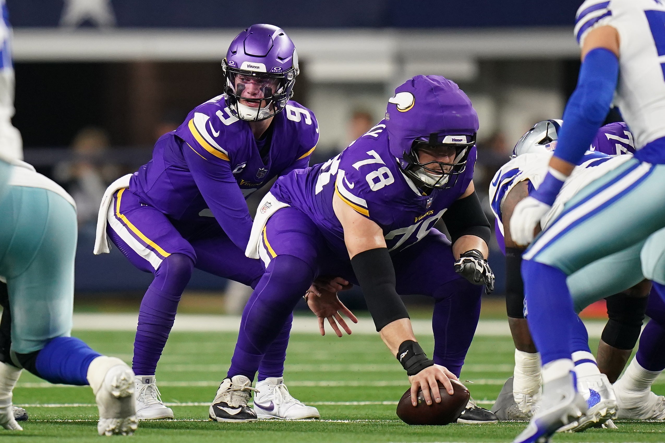 Dec 14, 2025; Arlington, Texas, USA; Minnesota Vikings quarterback J.J. McCarthy (9) under center Ryan Kelly (78) during the first half against the Minnesota Vikings at AT&T Stadium.