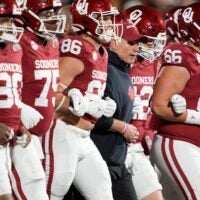Oklahoma coach Brent Venables locks arms with players before a first-round College Football Playoff game between the University of Oklahoma Sooners (OU) and the Alabama Crimson Tide at Gaylord Family – Oklahoma Memorial Stadium in Norman, Okla., Friday, Dec. 19, 2025.