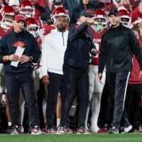 Offensive coordinator Ben Arbuckle talks with an official beside Oklahoma coach Brent Venables during a first-round College Football Playoff game between the University of Oklahoma Sooners (OU) and the Alabama Crimson Tide at Gaylord Family - Oklahoma Memorial Stadium in Norman, Okla., Friday, Dec. 19, 2025. Alabama won 34-24.