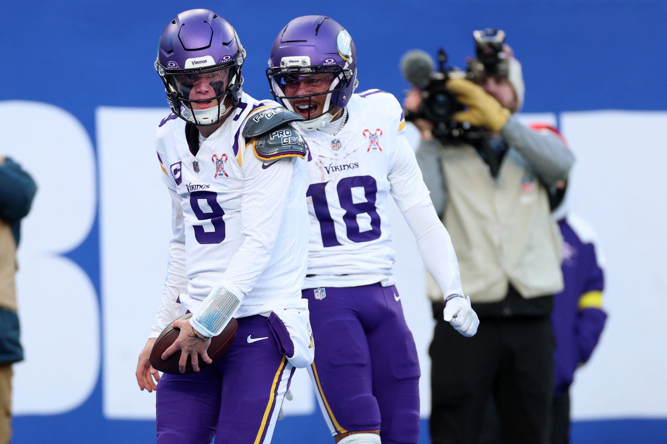 Dec 21, 2025; East Rutherford, New Jersey, USA; Minnesota Vikings quarterback J.J. McCarthy (9) reacts with wide receiver Justin Jefferson (18) after rushing for a touchdown against the New York Giants during the first half at MetLife Stadium.