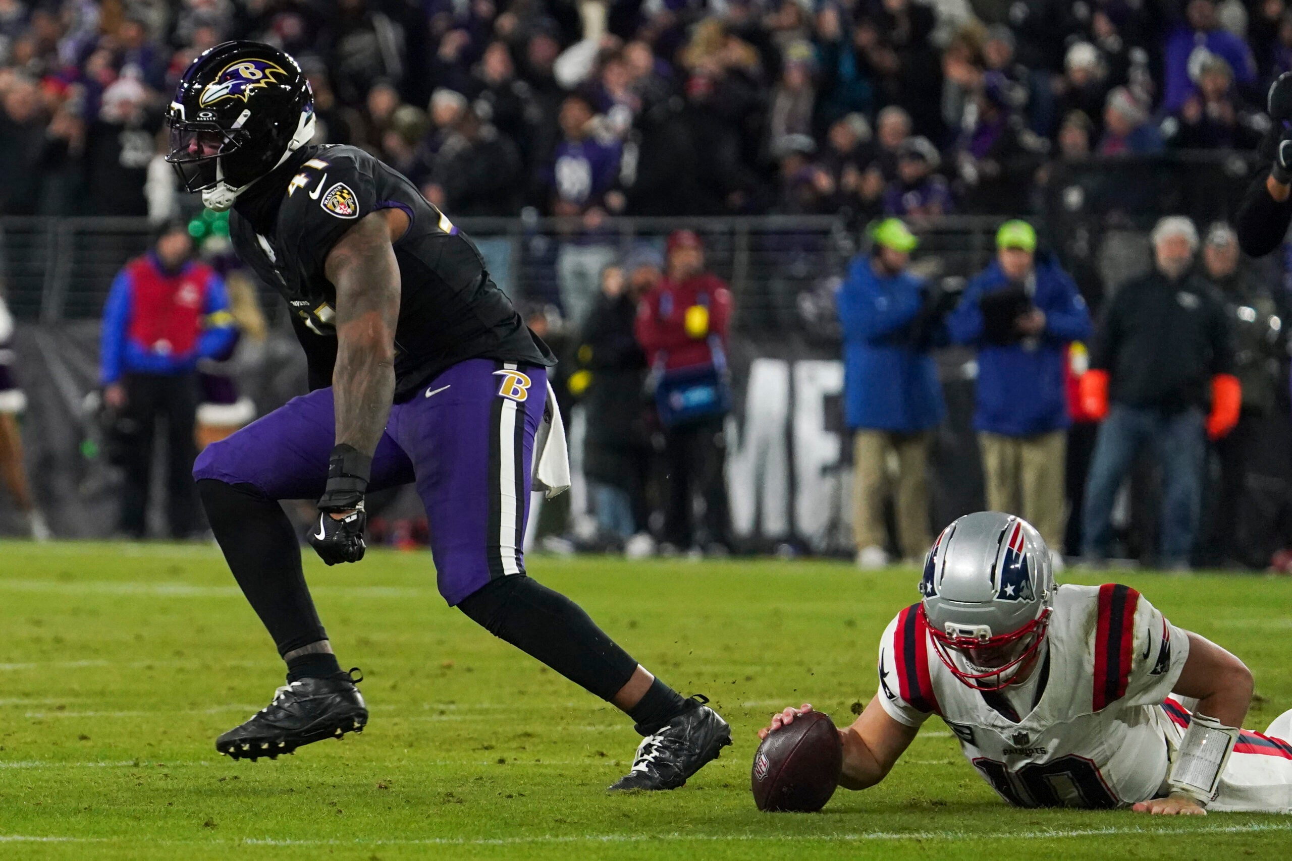 Dec 21, 2025; Baltimore, Maryland, USA; Baltimore Ravens defensive end Dre'Mont Jones (41) celebrates sacking New England Patriots quarterback Drake Maye (10) during the first half of the game at M&T Bank Stadium.