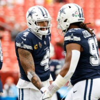 Dec 25, 2025; Landover, Maryland, USA; Dallas Cowboys quarterback Dak Prescott (4) greets defensive tackle Osa Odighizuwa (97) during warmups before the game against the Washington Commanders at Northwest Stadium.