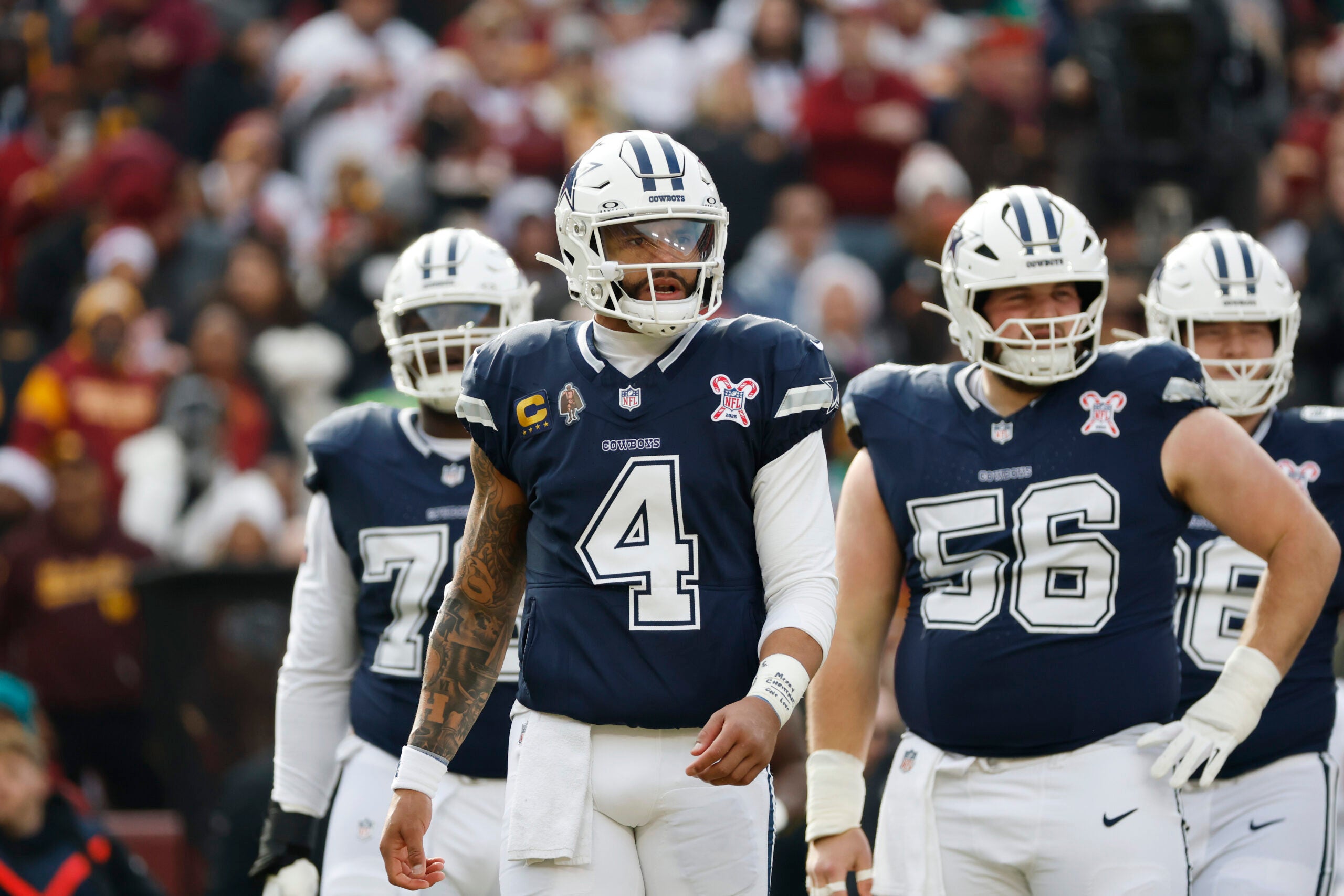 Dec 25, 2025; Landover, Maryland, USA; Dallas Cowboys quarterback Dak Prescott (4) looks on during a stoppage in play against the Washington Commanders during the first half at Northwest Stadium.