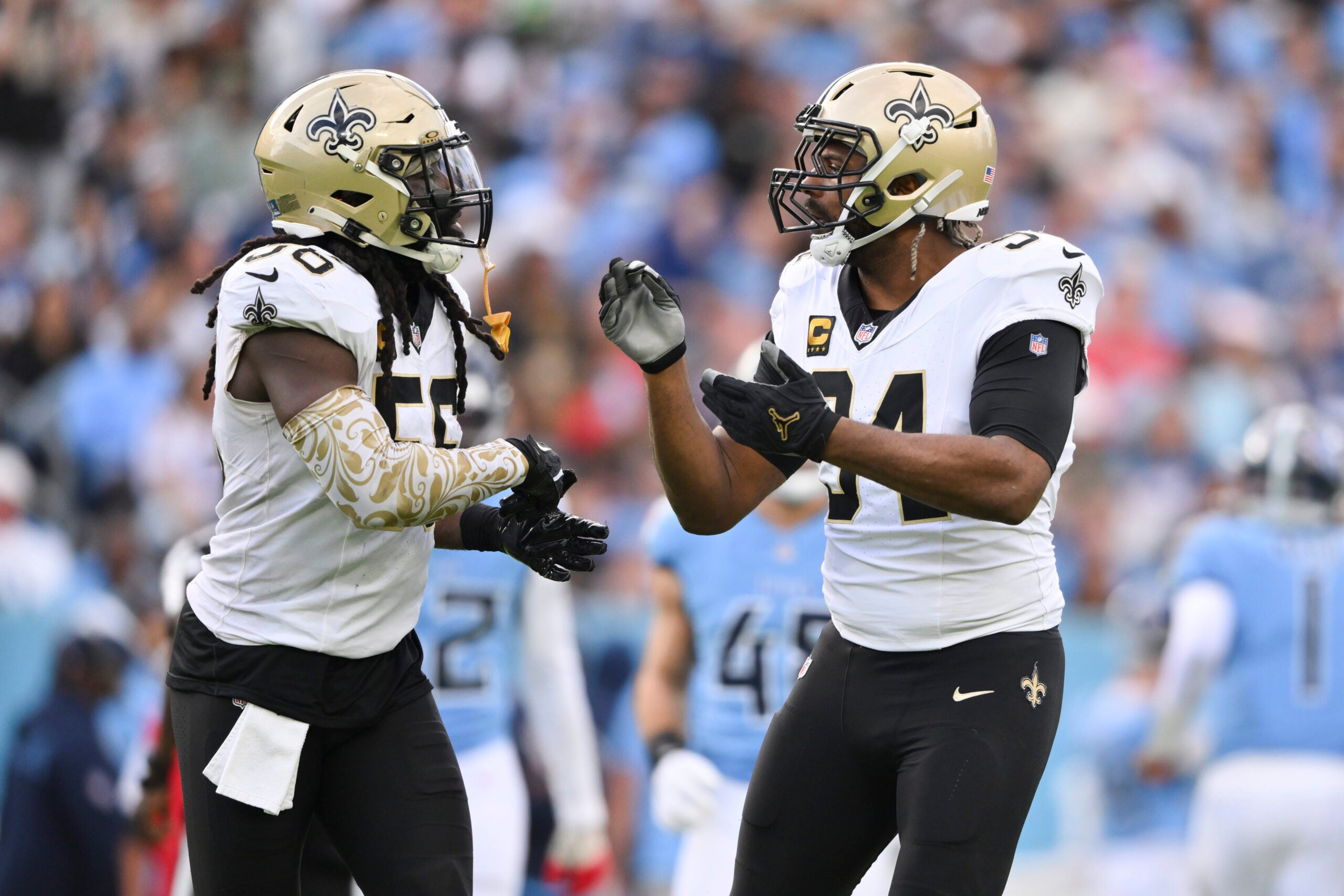 Dec 28, 2025; Nashville, Tennessee, USA; New Orleans Saints linebacker Demario Davis (56) and defensive end Cameron Jordan (94) celebrate a sack against the Tennessee Titans during the second half of the game at Nissan Stadium.