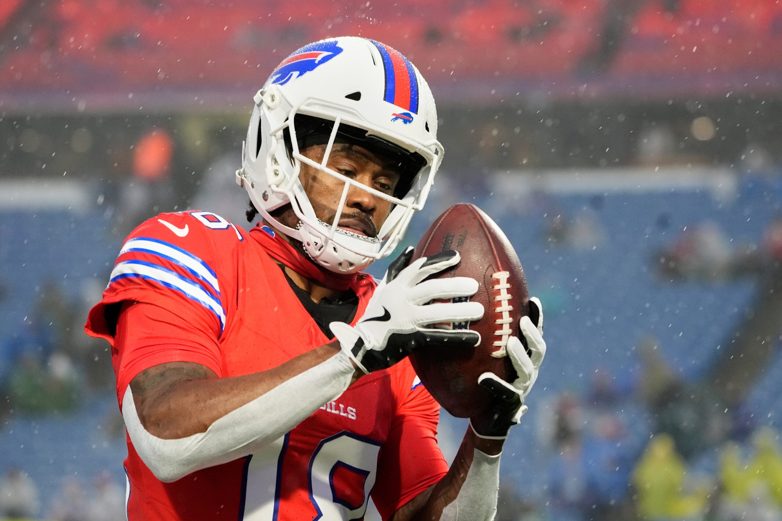 Dec 28, 2025; Orchard Park, New York, USA; Buffalo Bills wide receiver Brandin Cooks (18) warms up in the rain before the game against the Philadelphia Eagles at Highmark Stadium.