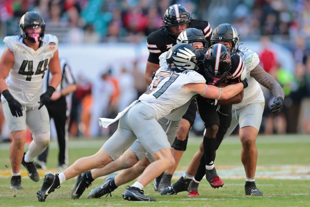 Jan 1, 2026; Miami Gardens, FL, USA; Texas Tech Red Raiders running back J'Koby Williams (20) is tackled by Oregon Ducks defensive back Dillon Thieneman (31) during the second half of the 2025 Orange Bowl and quarterfinal game of the College Football Playoff at Hard Rock Stadium.