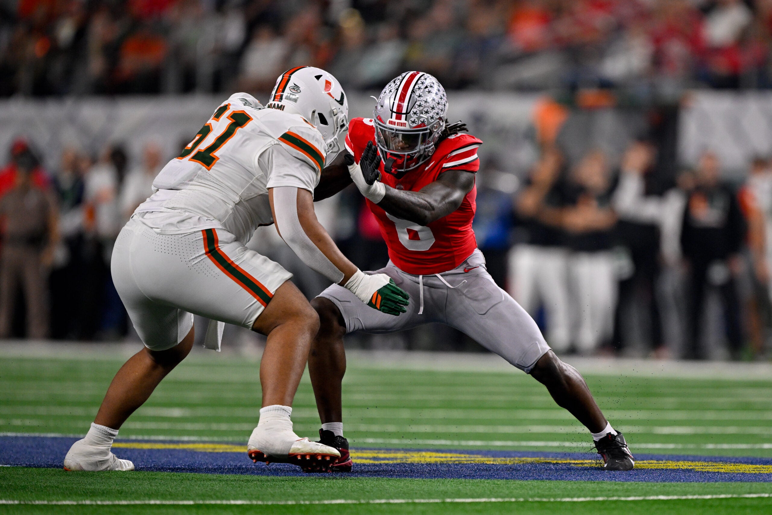 Dec 31, 2025; Arlington, TX, USA; Miami Hurricanes offensive lineman Francis Mauigoa (61) blocks Ohio State Buckeyes linebacker Arvell Reese (8) during the 2025 Cotton Bowl and quarterfinal game of the College Football Playoff at AT&T Stadium. Mandatory Credit: Jerome Miron-Imagn Images