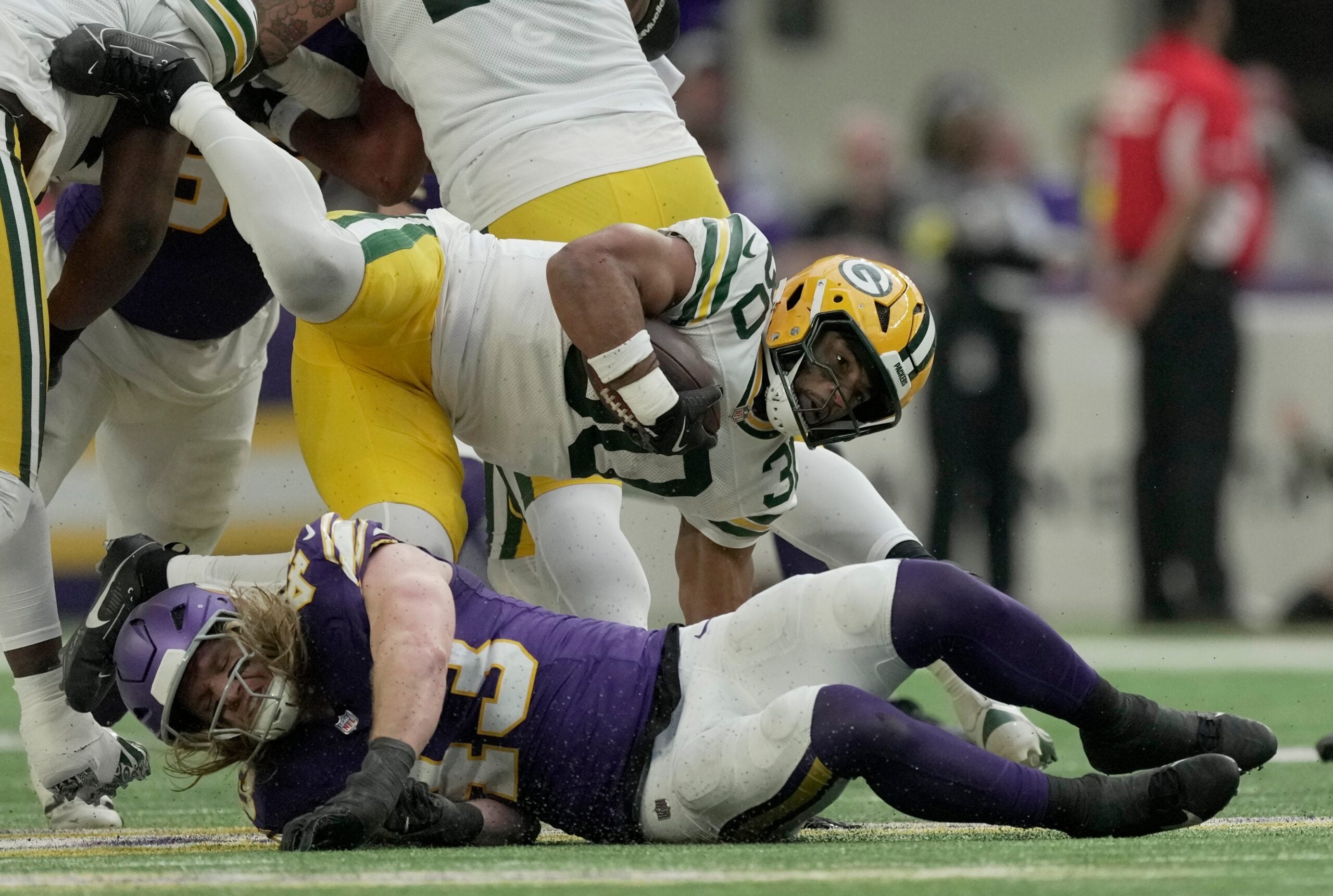 Green Bay Packers running back Chris Brooks (30) is stopped at the line by Minnesota Vikings linebacker Andrew van Ginkel (43) during the third quarter of their game Sunday, January 4, 2026 at U.S. Bank Stadium in Minneapolis, Minnesota.