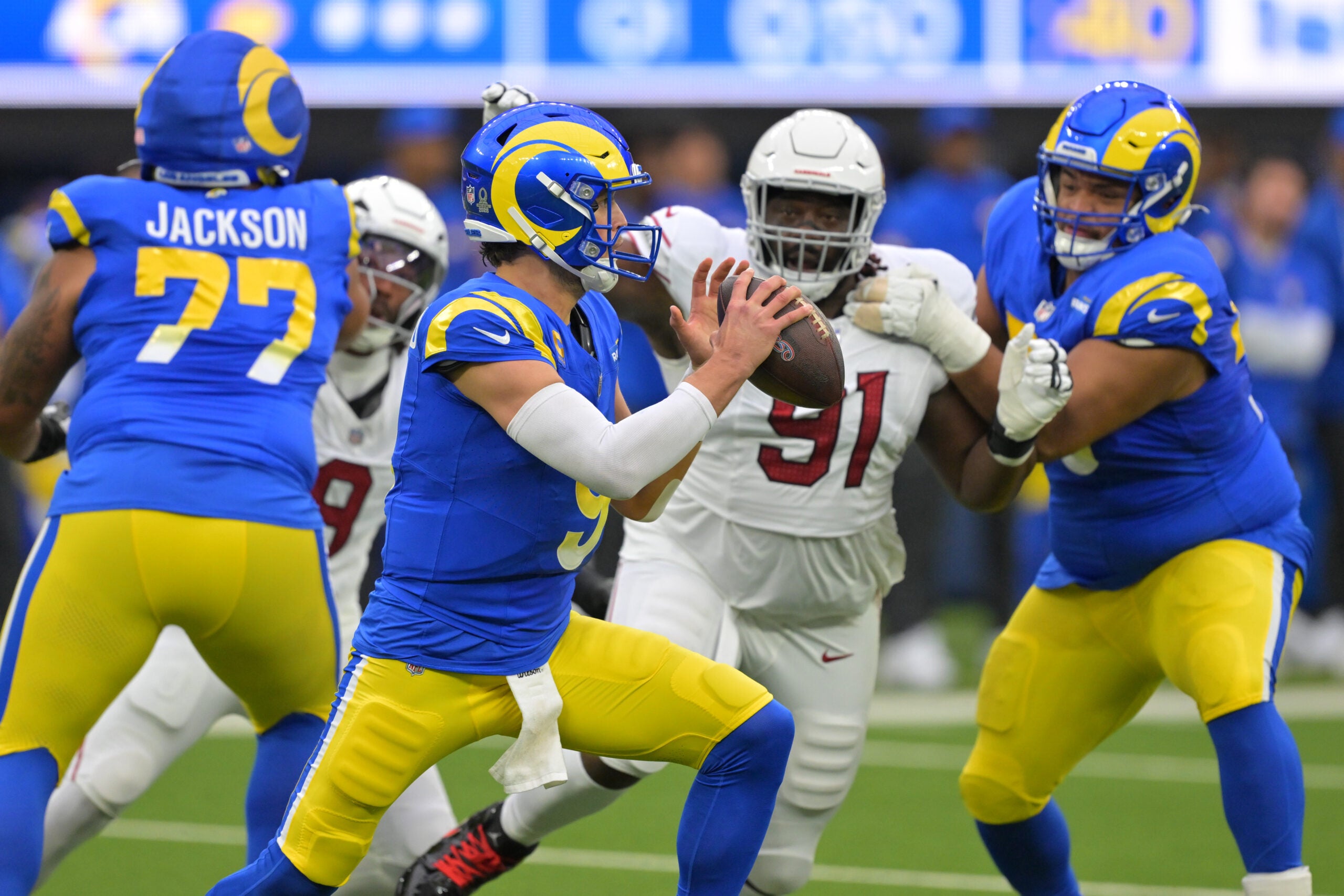 Jan 4, 2026; Inglewood, California, USA; Los Angeles Rams quarterback Matthew Stafford (9) is pressured by Arizona Cardinals defensive end L.J. Collier (91) during the first half at SoFi Stadium.