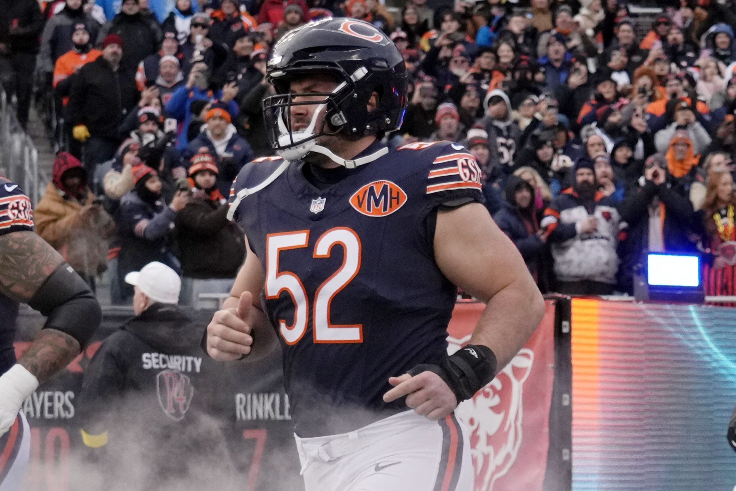 Jan 4, 2026; Chicago, Illinois, USA; Chicago Bears center Drew Dalman (52) runs onto the field before the game between the Chicago Bears and the Detroit Lions at Soldier Field.