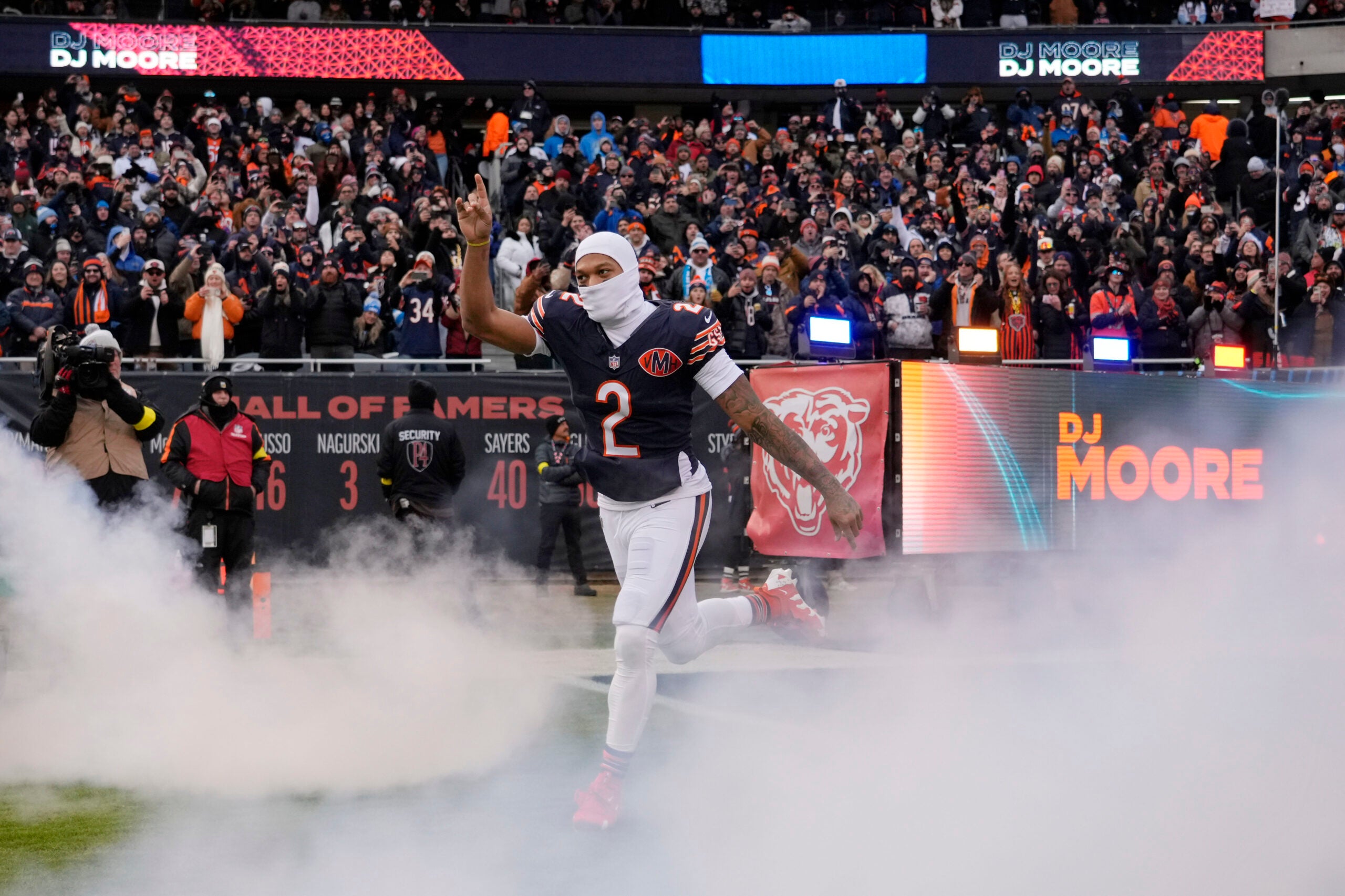 Jan 4, 2026; Chicago, Illinois, USA; Chicago Bears wide receiver DJ Moore (2) runs onto the field before the game between the Chicago Bears and the Detroit Lions at Soldier Field.
