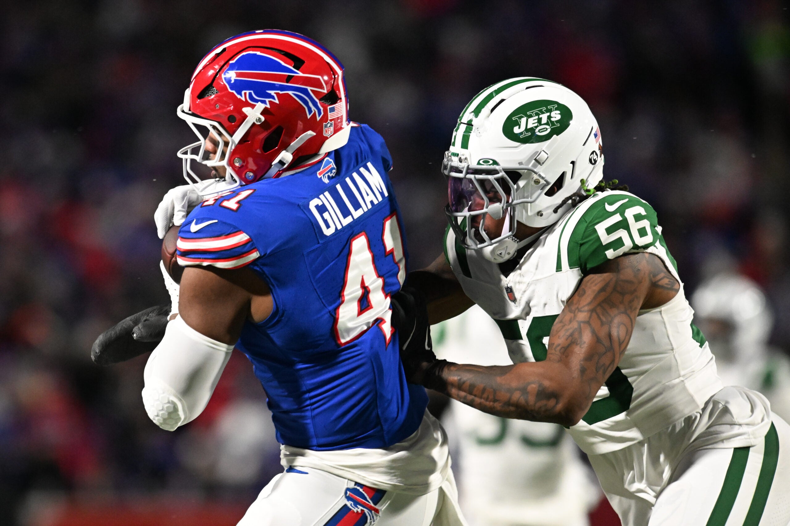 Jan 4, 2026; Orchard Park, New York, USA; Buffalo Bills fullback Reggie Gilliam (41) makes a catch defended by New York Jets linebacker Quincy Williams (56) during the second quarter at Highmark Stadium.
