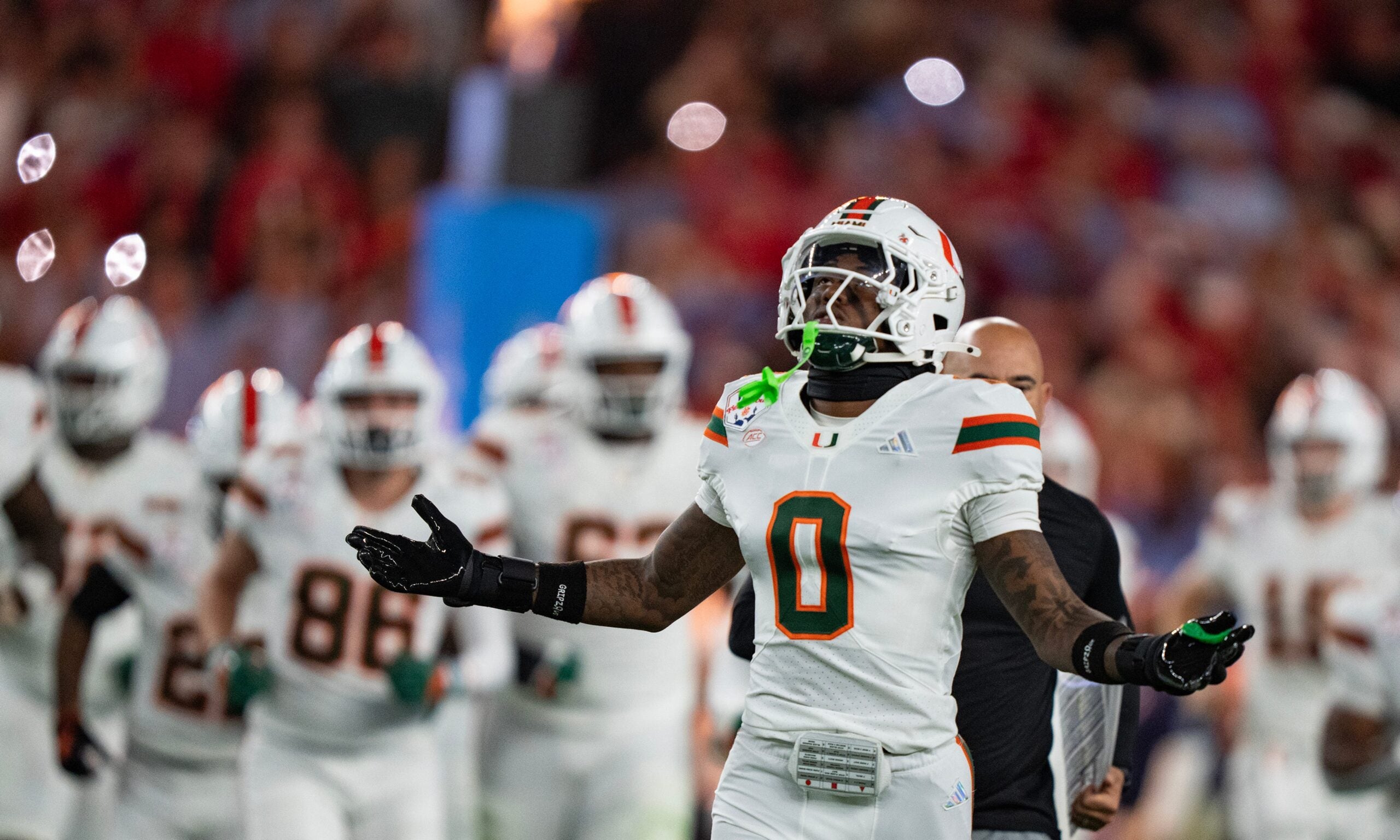 Miami Hurricanes defensive back Keionte Scott (0) runs onto the field at the start of the CFP Fiesta Bowl against Ole Miss at the State Farm Stadium, in Glendale, Ariz., on Thursday, Jan. 8, 2026.