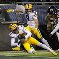 Jan 10, 2026; Chicago, IL, USA; Green Bay Packers wide receiver Matthew Golden (0) scores a touchdown against Chicago Bears defensive end Montez Sweat (98) in the third quarter during an NFC Wild Card Round game at Soldier Field.