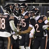 Jan 10, 2026; Chicago, IL, USA; Chicago Bears quarterback Caleb Williams (18) and wide receiver DJ Moore (2) react after hooking up on the eventually game winning touchdown against the Green Bay Packers during the second half of an NFC Wild Card Round game at Soldier Field.