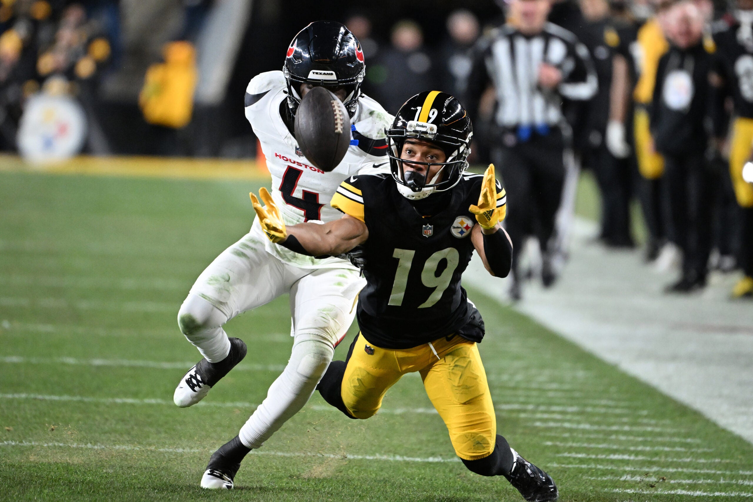 Jan 12, 2026; Pittsburgh, PA, USA; Pittsburgh Steelers wide receiver Calvin Austin III (19) reaches for an incomplete pass against Houston Texans cornerback Kamari Lassiter (4) during the second half of an AFC Wild Card Round game at Acrisure Stadium.