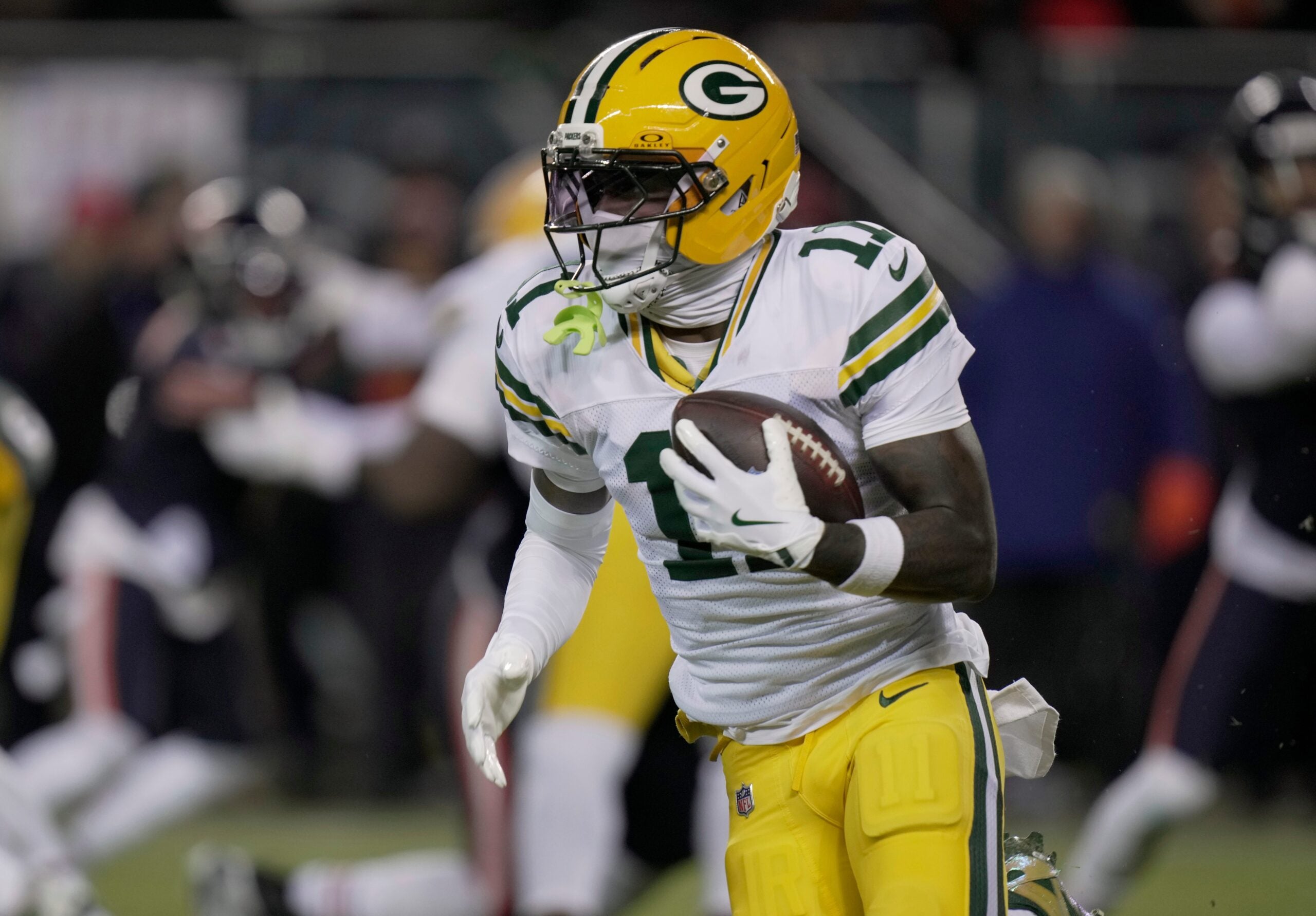 Green Bay Packers wide receiver Jayden Reed (11) runs the ball during the first quarter of their wild card playoff game against the Chicago Bears Saturday, January 10, 2026 at Soldier Field in Chicago, Illinois.