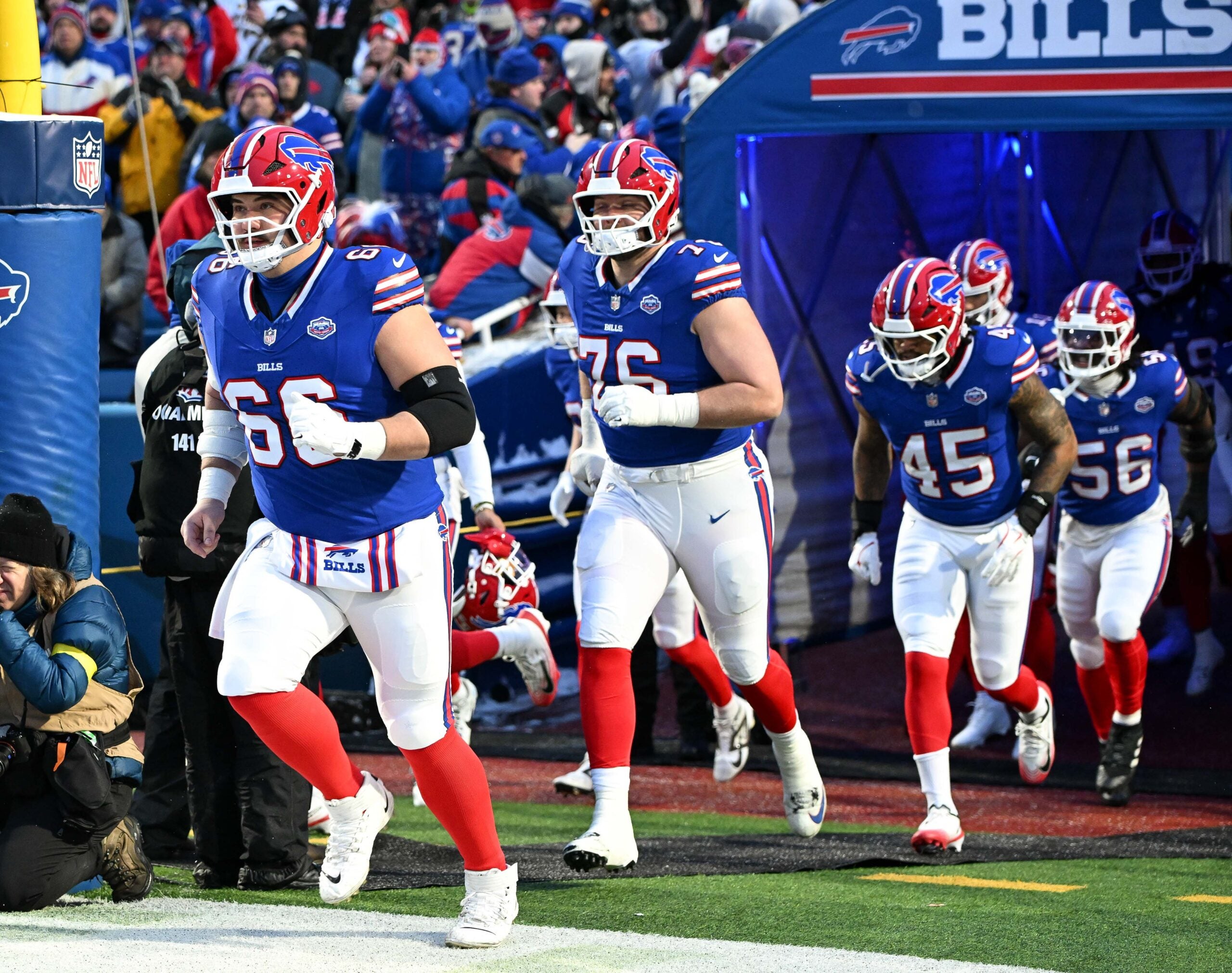 Jan 4, 2026; Orchard Park, New York, USA; Buffalo Bills center Connor McGovern (66) and guard David Edwards (76) lead the team onto the field before a game against the New York Jets at Highmark Stadium.