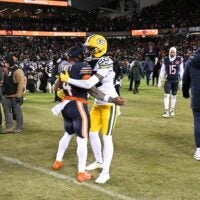 Jan 10, 2026; Chicago, IL, USA; in Chicago Bears running back D'Andre Swift (4) and Green Bay Packers cornerback Trevon Diggs (28) hug after an NFC Wild Card Round game at Soldier Field.
