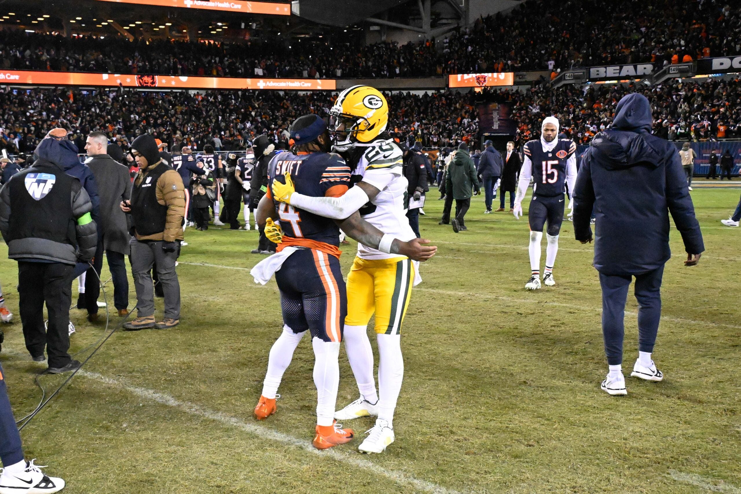 Jan 10, 2026; Chicago, IL, USA; in Chicago Bears running back D'Andre Swift (4) and Green Bay Packers cornerback Trevon Diggs (28) hug after an NFC Wild Card Round game at Soldier Field.