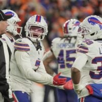 Buffalo Bills cornerback Taron Johnson argues the call for holding with back judge Scott Helverson during overtime at Empower FIeld at Mile High in Denver, Colorado on Jan. 17, 2026.