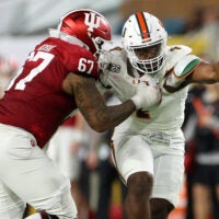 Jan 19, 2026; Miami Gardens, FL, USA; Indiana Hoosiers offensive lineman Kahlil Benson (67) attempts to block Miami Hurricanes defensive lineman Rueben Bain Jr. (4) in the first half during the College Football Playoff National Championship game at Hard Rock Stadium.