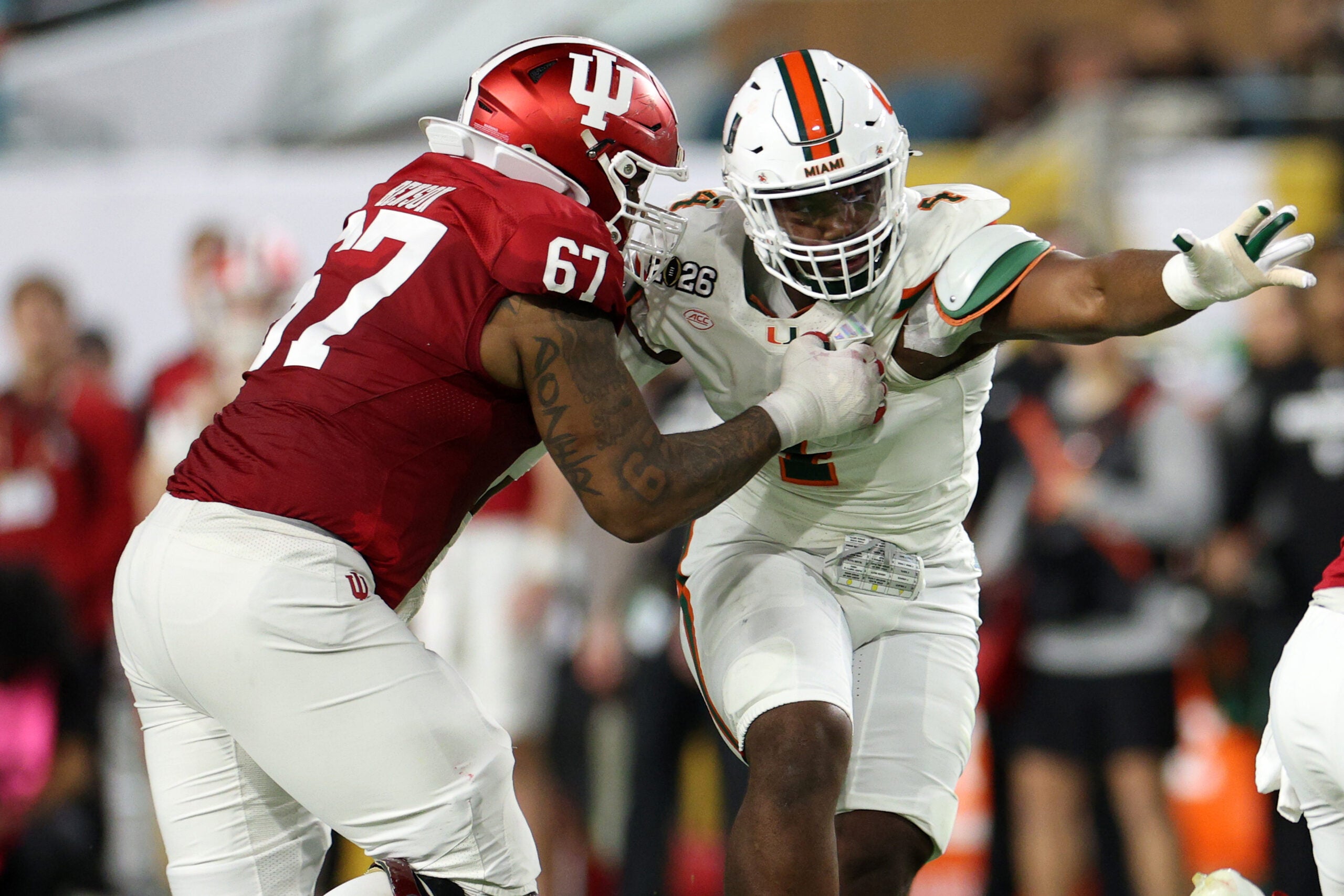 Jan 19, 2026; Miami Gardens, FL, USA; Indiana Hoosiers offensive lineman Kahlil Benson (67) attempts to block Miami Hurricanes defensive lineman Rueben Bain Jr. (4) in the first half during the College Football Playoff National Championship game at Hard Rock Stadium.