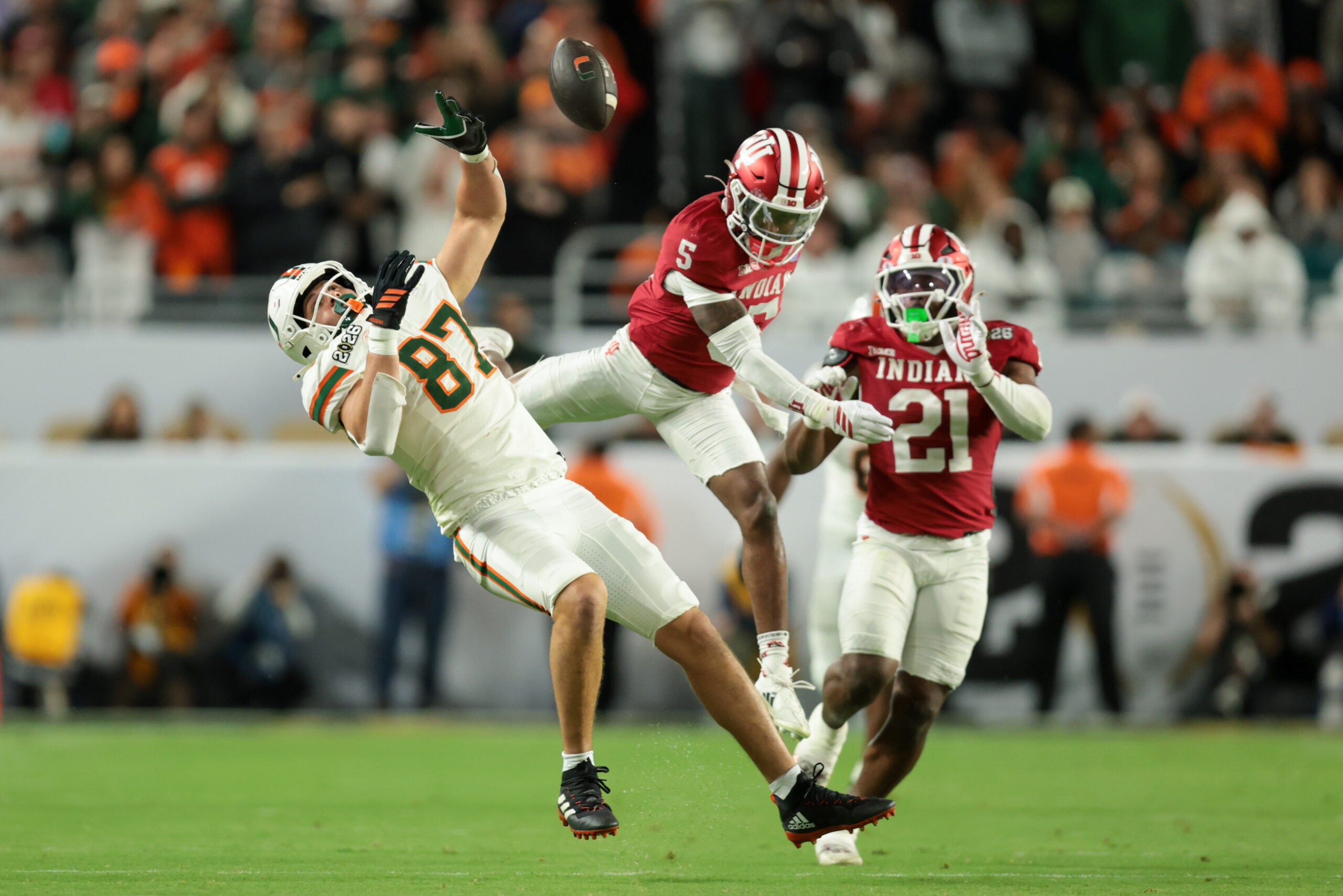 Jan 19, 2026; Miami Gardens, FL, USA; Miami Hurricanes tight end Alex Bauman (87) is unable to make a catch defended by Indiana Hoosiers defensive back D'Angelo Ponds (5) and linebacker Rolijah Hardy (21) in the third quarter during the College Football Playoff National Championship game at Hard Rock Stadium. Mandatory Credit: Sam Navarro-Imagn Images