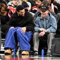 Jan 20, 2026; Chicago, Illinois, USA; Chicago Bears quarterback Caleb Williams, left, and Chicago Cubs outfielder Pete Crow-Armstrong are seen during the first half of the game between the Chicago Bulls and the LA Clippers at United Center.