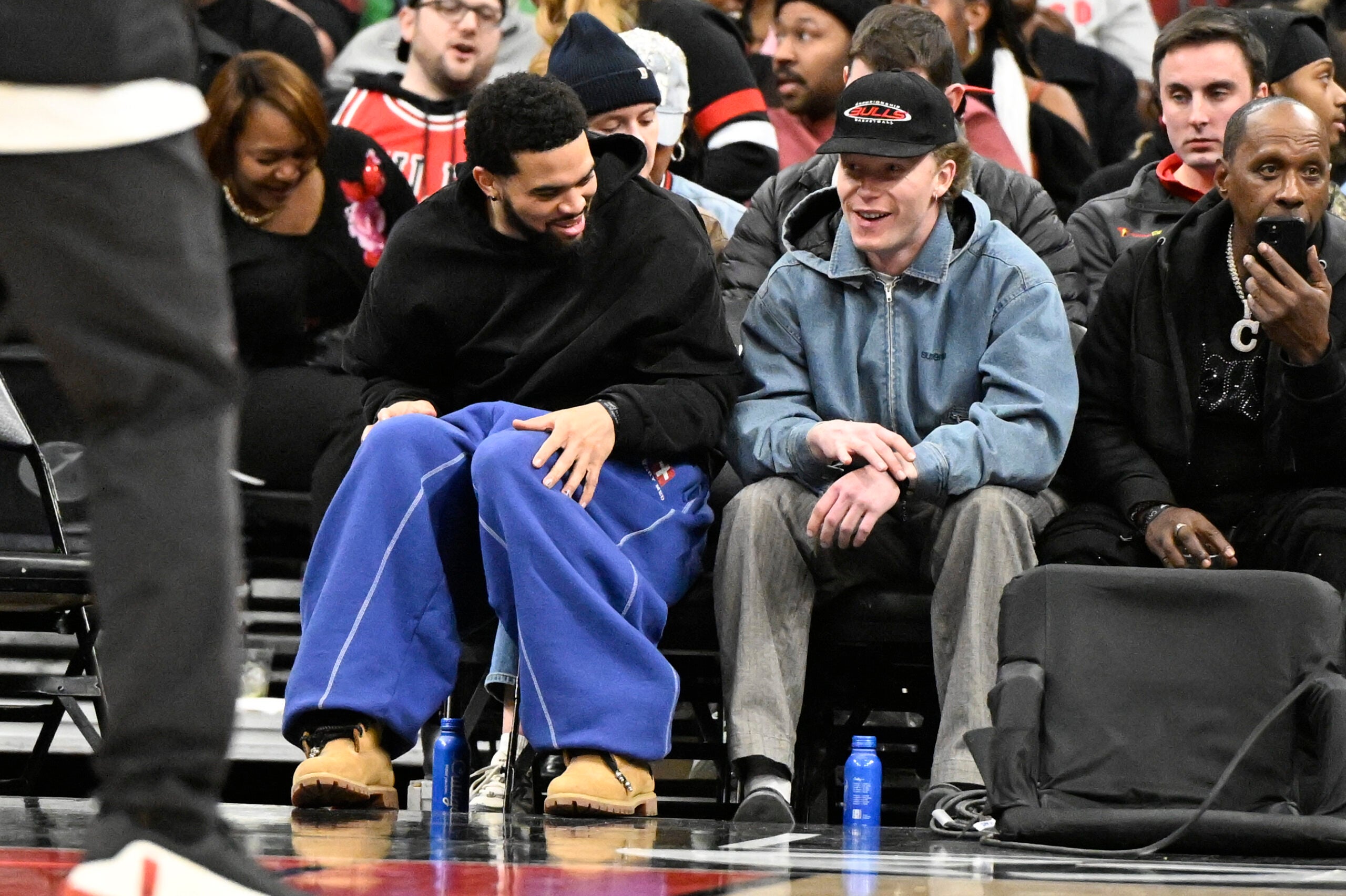 Jan 20, 2026; Chicago, Illinois, USA; Chicago Bears quarterback Caleb Williams, left, and Chicago Cubs outfielder Pete Crow-Armstrong are seen during the first half of the game between the Chicago Bulls and the LA Clippers at United Center.