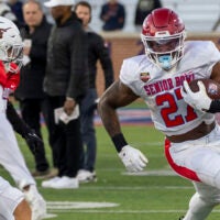 Jan 28, 2026; Mobile, AL, USA; American Team running back Mike Washington Jr. (27) of Arkansas runs the ball during American Senior Bowl practice at Hancock Whitney Stadium. Mandatory Credit: Vasha Hunt-Imagn Images