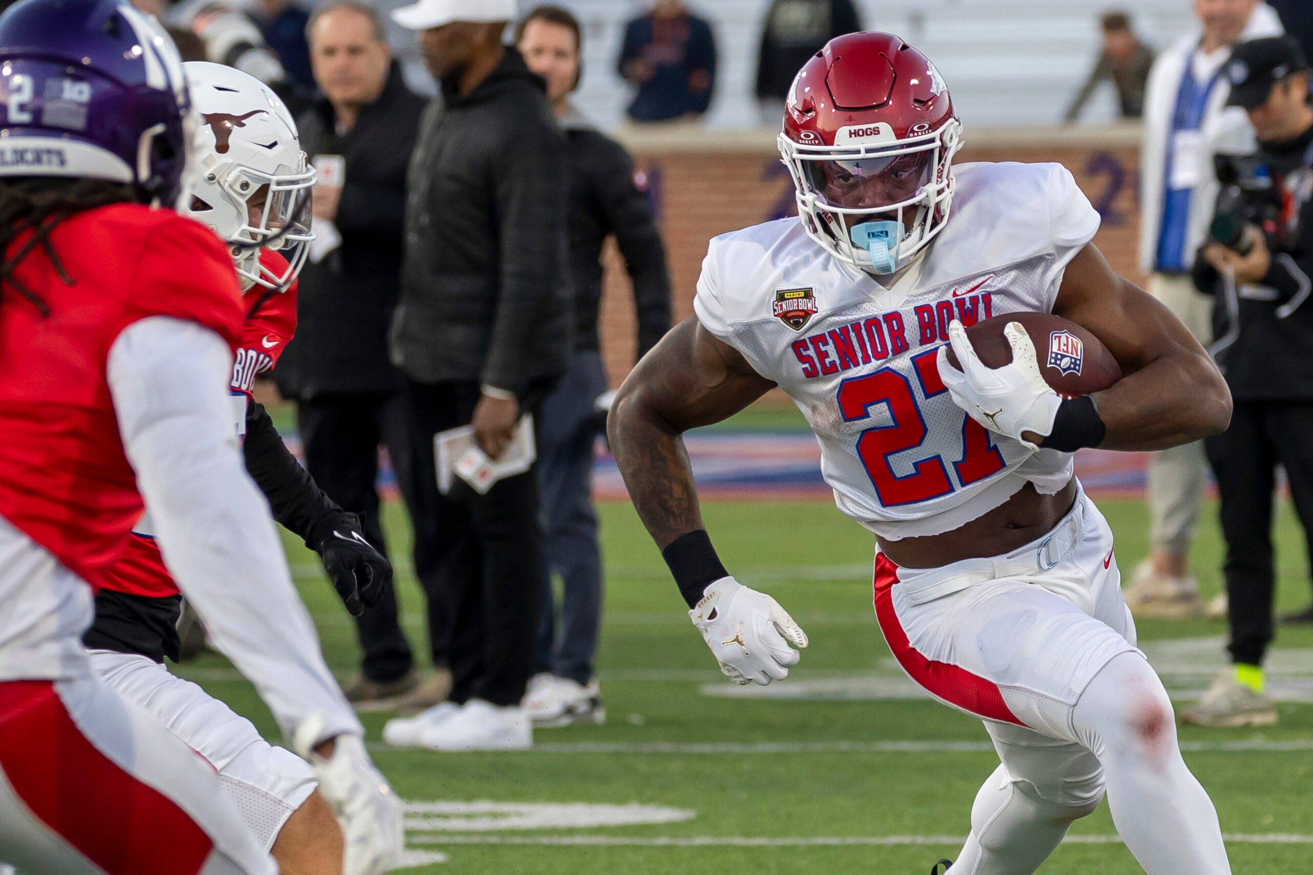 Jan 28, 2026; Mobile, AL, USA; American Team running back Mike Washington Jr. (27) of Arkansas runs the ball during American Senior Bowl practice at Hancock Whitney Stadium. Mandatory Credit: Vasha Hunt-Imagn Images