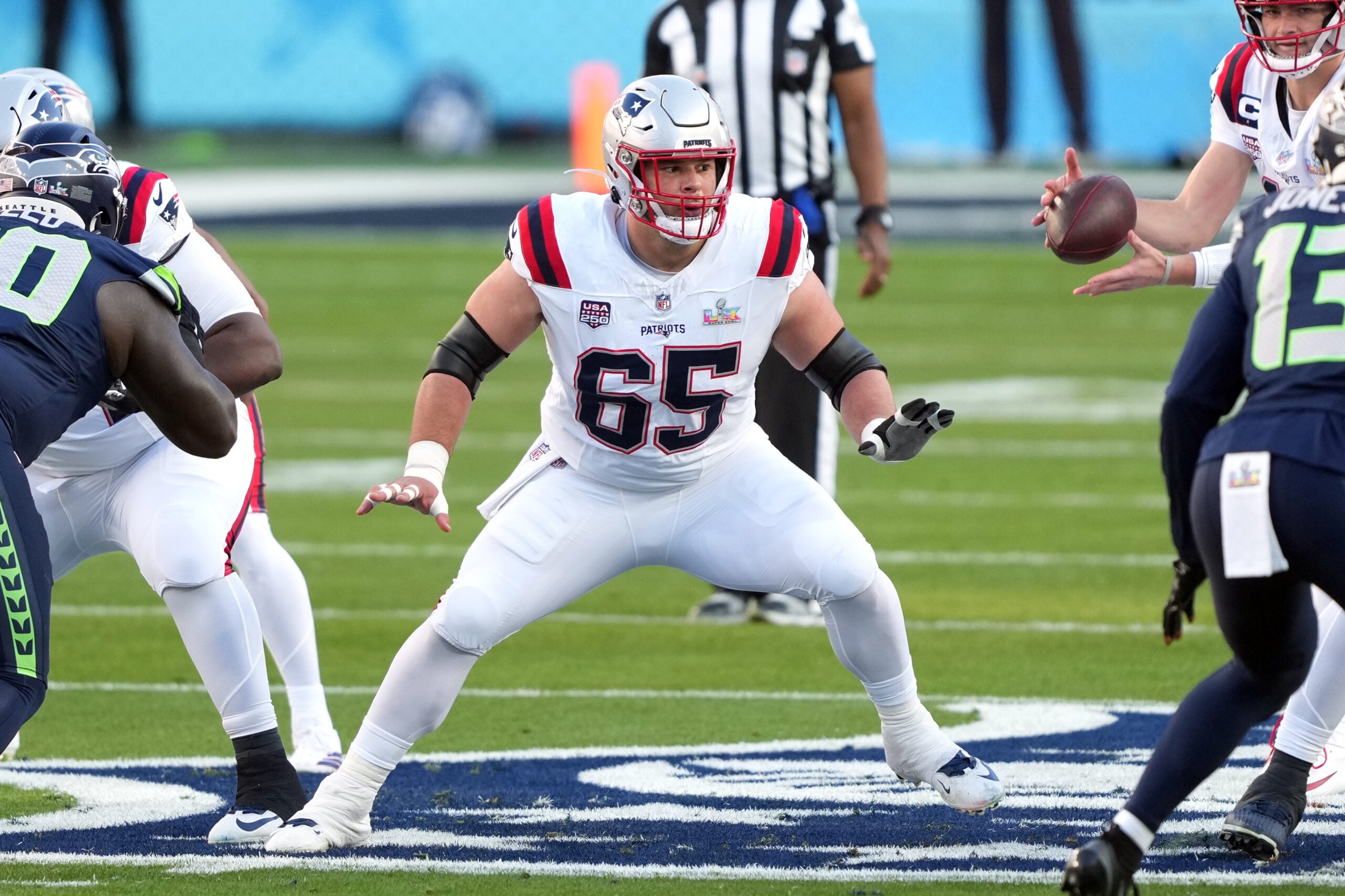 Feb 8, 2026; Santa Clara, CA, USA; New England Patriots center Garrett Bradbury (65) blocks against the Seattle Seahawks during the first quarter in Super Bowl LX at Levi's Stadium.