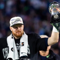 Feb 8, 2026; Santa Clara, CA, USA; Seattle Seahawks quarterback Sam Darnold (14) celebrates with the Vince Lombardi Trophy after defeating the New England Patriots during Super Bowl LX at Levi's Stadium.