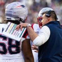 Feb 8, 2026; Santa Clara, CA, USA; New England Patriots head coach Mike Vrabel in the huddle with guard Jared Wilson (58) against the Seattle Seahawks during Super Bowl LX at Levi's Stadium.