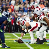 Feb 8, 2026; Santa Clara, CA, USA;General view down the line of scrimmage as New England Patriots center Garrett Bradbury (65) prepares to snap the ball against the Seattle Seahawks during Super Bowl LX at Levi's Stadium.