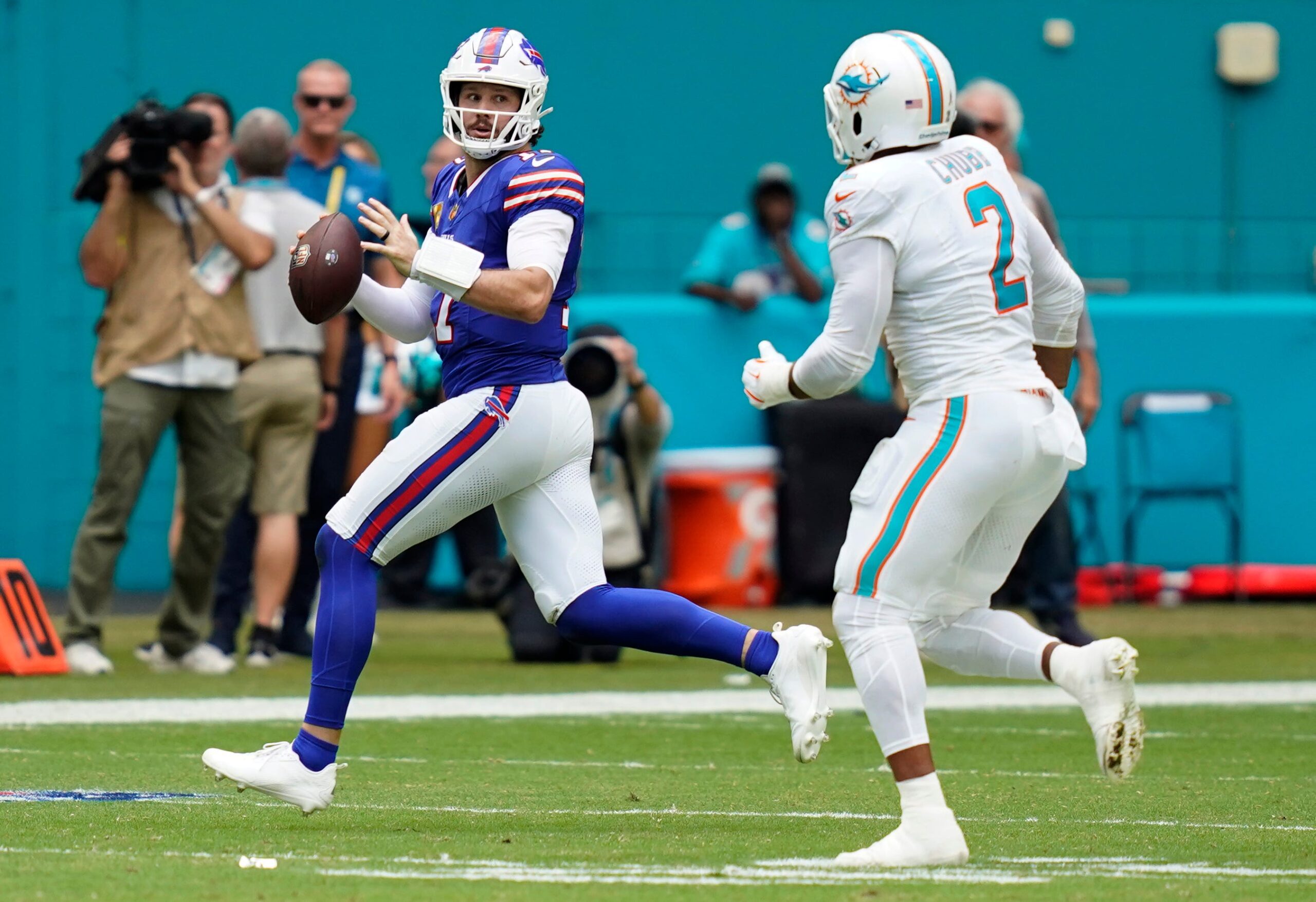 Nov 9, 2025; Miami Gardens, Florida, USA; Buffalo Bills quarterback Josh Allen (17) scrambles against Miami Dolphins linebacker Bradley Chubb (2) during the first half at Hard Rock Stadium.