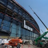 Construction crews install the first panels on the stadium exterior as work continues on the Buffalo Bills new stadium, across the street from their current home at Highmark Stadium, in Orchard Park, NY Thursday, July 10, 2025.