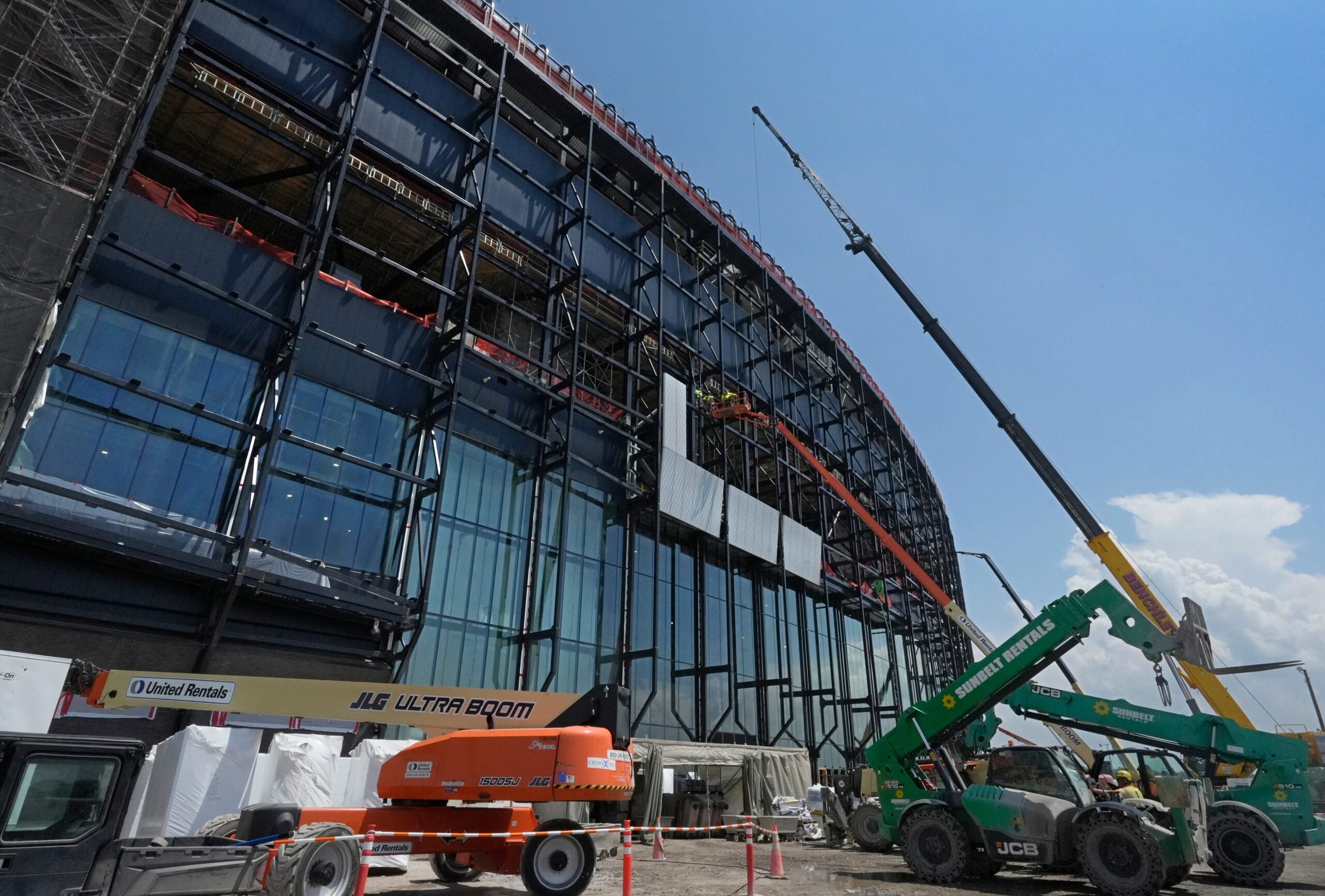 Construction crews install the first panels on the stadium exterior as work continues on the Buffalo Bills new stadium, across the street from their current home at Highmark Stadium, in Orchard Park, NY Thursday, July 10, 2025.