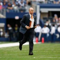 Nov 2, 2014; Arlington, TX, USA; Dallas Cowboys team physician Dan Cooper runs onto the field to help an injured player against the Arizona Cardinals at AT&T Stadium.