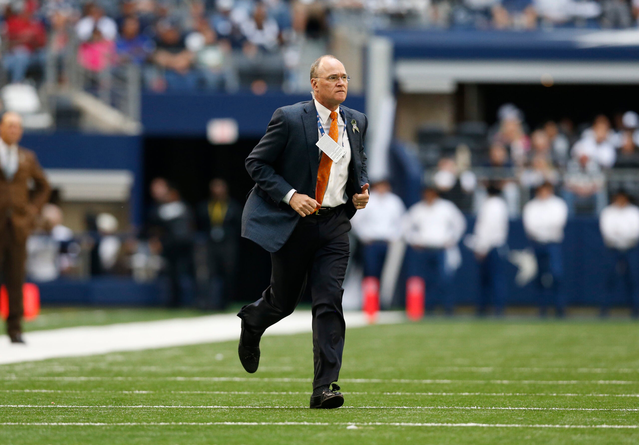 Nov 2, 2014; Arlington, TX, USA; Dallas Cowboys team physician Dan Cooper runs onto the field to help an injured player against the Arizona Cardinals at AT&T Stadium.