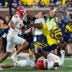 Michigan quarterback Alex Orji (10) is tackled by Fresno State defensive back Al'zillion Hamilton (3) during the second half at Michigan Stadium in Ann Arbor on Saturday, Aug. 31, 2024.